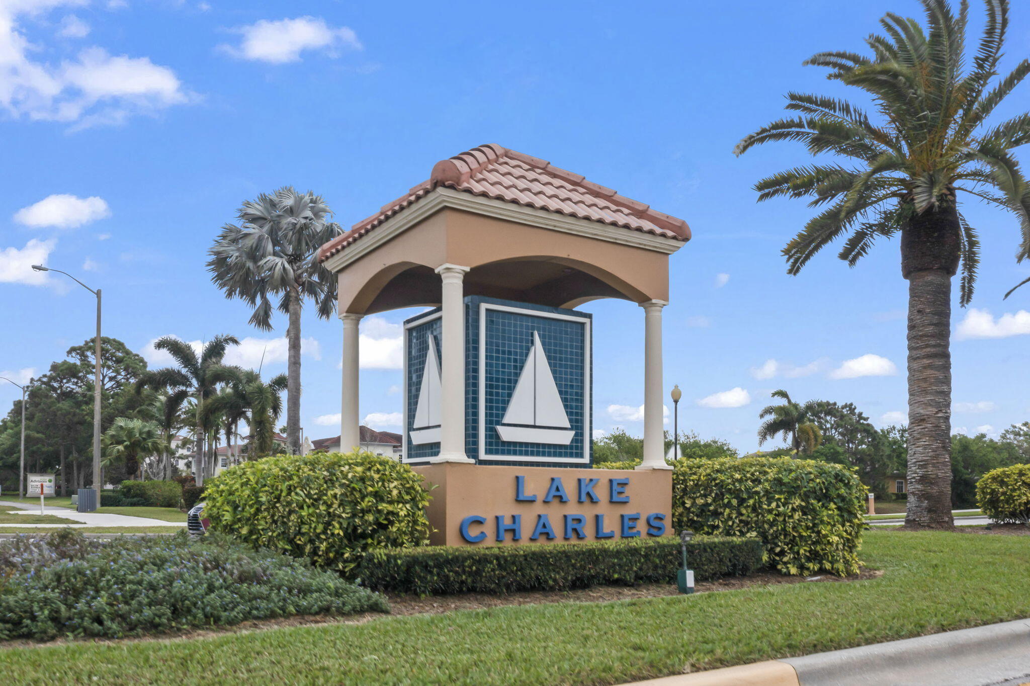 1604 Southwest Harbour Isles Circle, Unit 82 Port St. Lucie, FL 34986 - Photo 27 of 38 a front view of a house with a garden