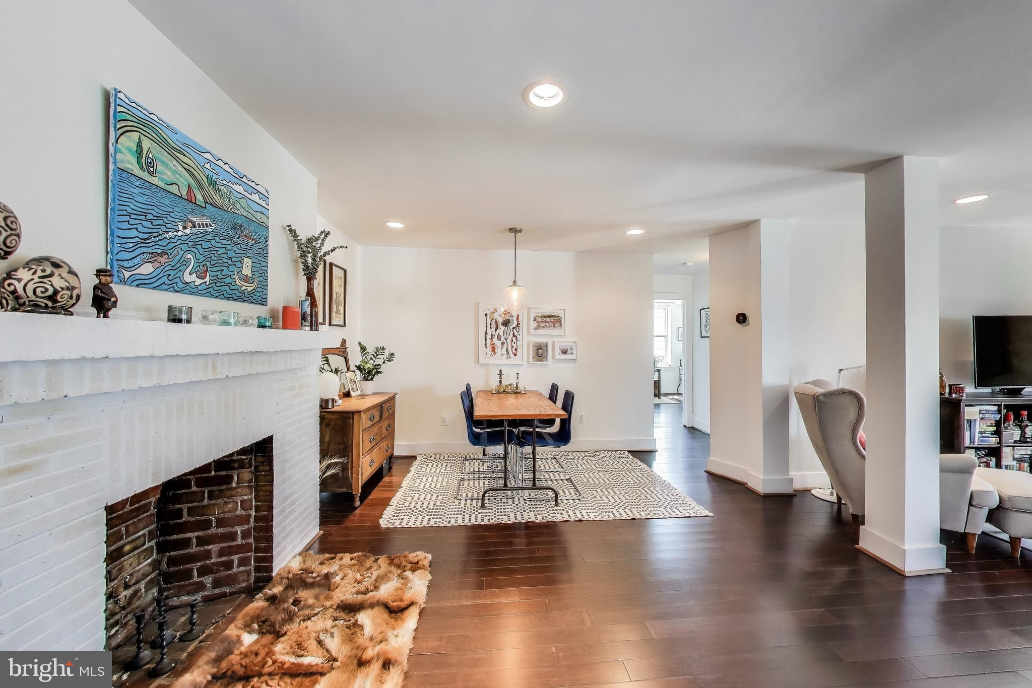 1461 Girard Street Northwest, Unit 400 Washington, DC 20009 - Photo 2 of 13 a living room with furniture and a fireplace