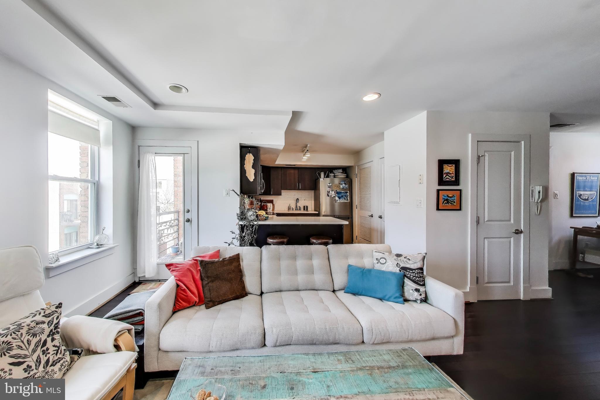 1461 Girard Street Northwest, Unit 400 Washington, DC 20009 - Photo 4 of 13 a living room with furniture and a flat screen tv
