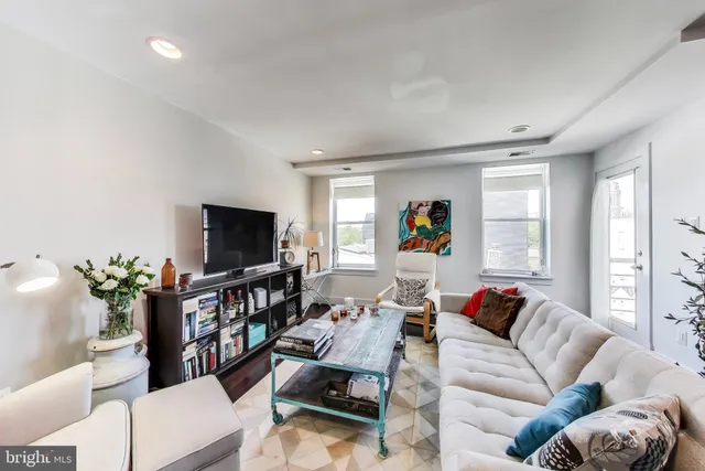 a living room with furniture and a flat screen tv