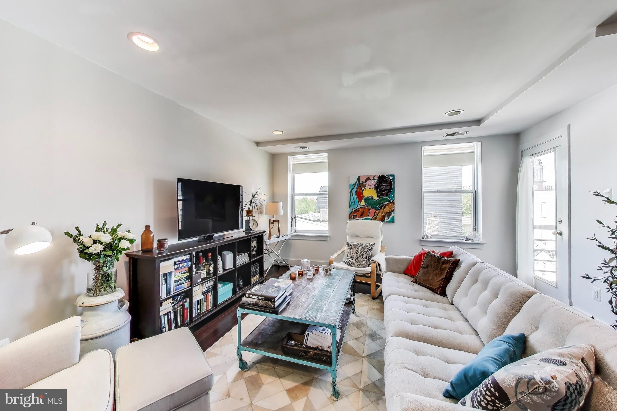 1461 Girard Street Northwest, Unit 400 Washington, DC 20009 - Photo 5 of 13 a living room with furniture and a flat screen tv
