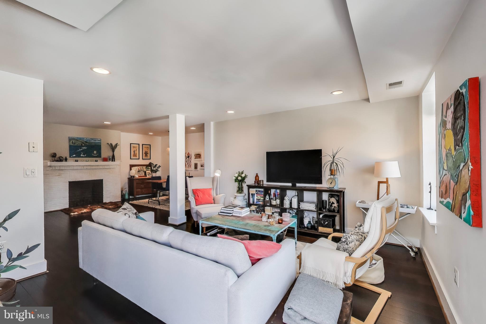 1461 Girard Street Northwest, Unit 400 Washington, DC 20009 - Photo 6 of 13 a living room with furniture and a flat screen tv