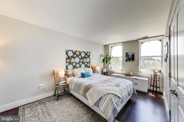 a bedroom with a bed and large window