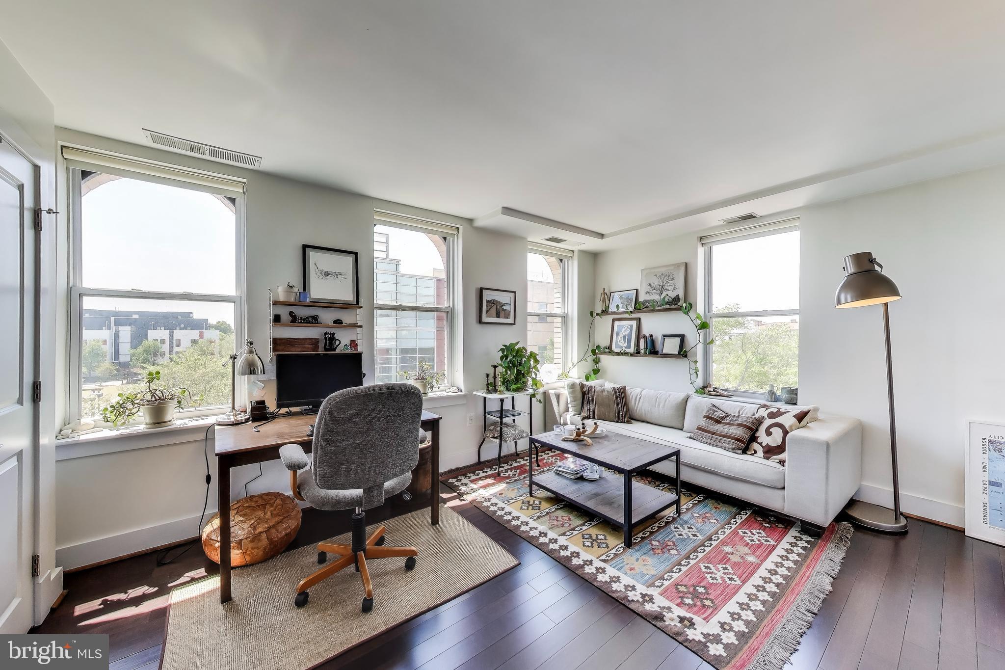 1461 Girard Street Northwest, Unit 400 Washington, DC 20009 - Photo 9 of 13 a living room with furniture and a window