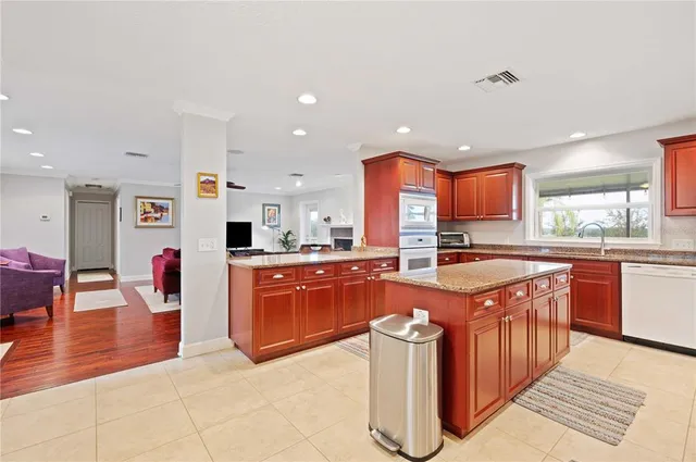 a kitchen with stainless steel appliances granite countertop a sink and cabinets