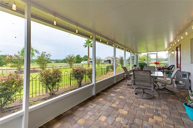 a very nice looking room with a large window and sitting area