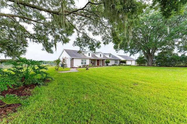 a front view of house with yard and green space