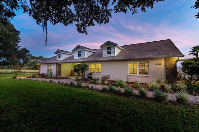 a front view of a house with a garden