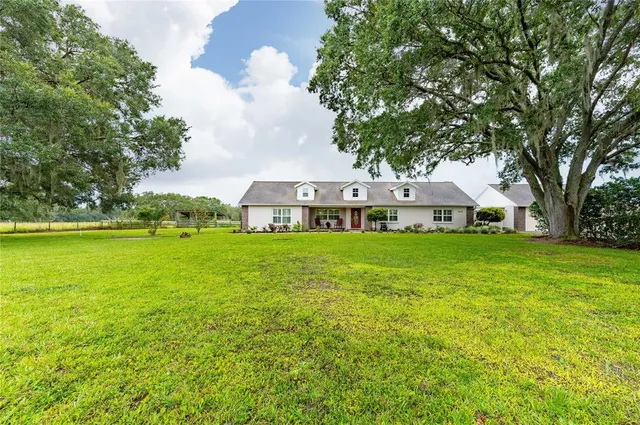 a view of house with garden space and trees