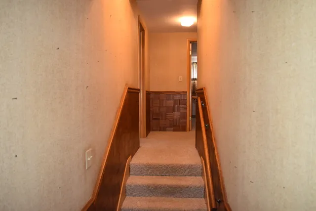 a white toilet sitting next to a white sink and vanity