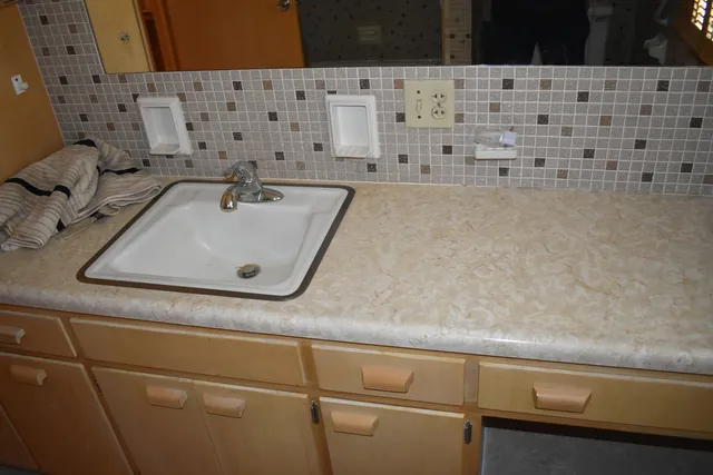 a view of room with cabinets and flat screen tv