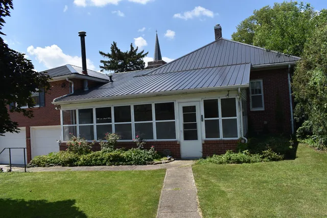 a view of a house with wooden fence