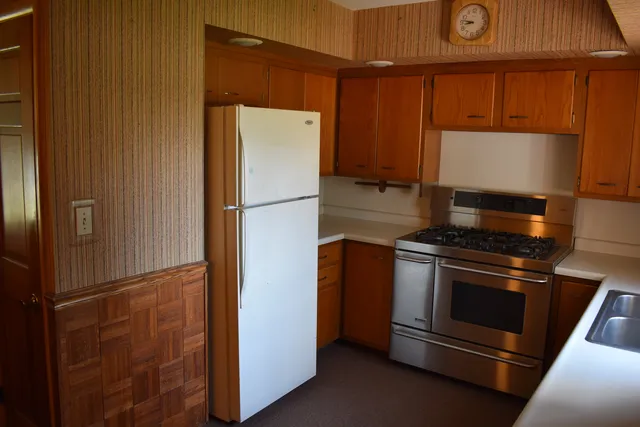 a kitchen with a refrigerator and a stove
