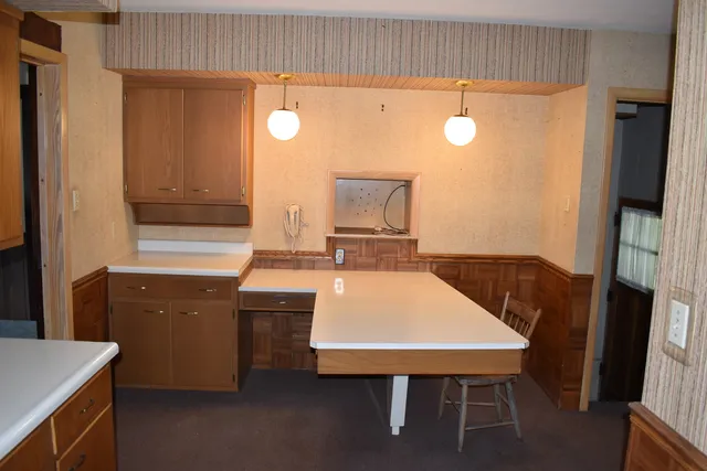 a room with table chairs and entryway