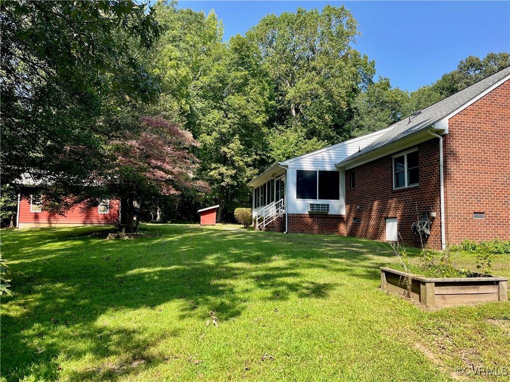 9611 Old Forge Road Providence Forge, VA 23140 - Photo 12 of 38 a front view of house with a garden and trees