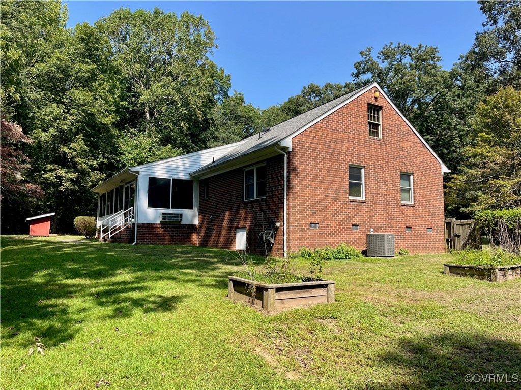 9611 Old Forge Road Providence Forge, VA 23140 - Photo 13 of 38 a front view of house with yard and trees in the background
