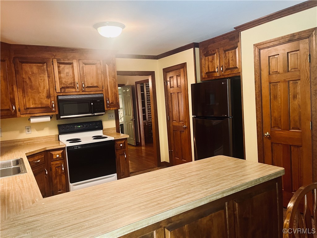9611 Old Forge Road Providence Forge, VA 23140 - Photo 25 of 38 a kitchen with granite countertop a refrigerator stove and oven