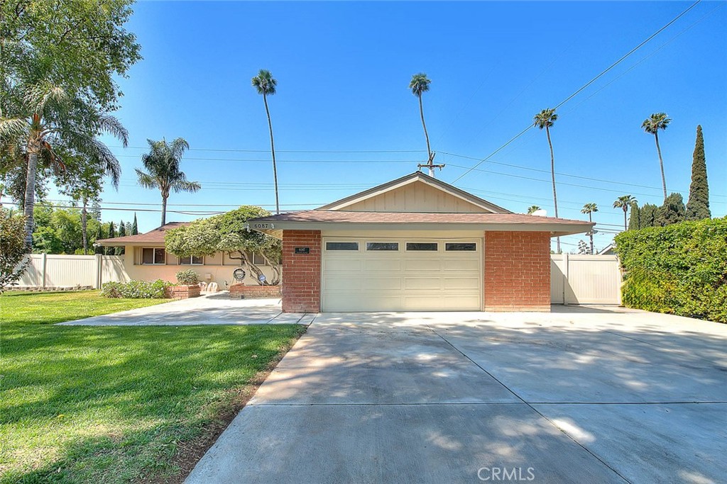 6087 Academy Avenue Riverside, CA 92506 - Photo 1 of 1 a front view of a house with a yard and garage