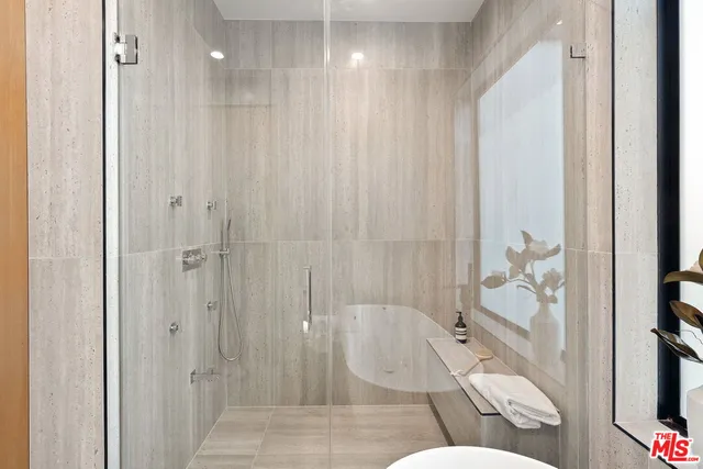 a bedroom with a large bed and a mirror