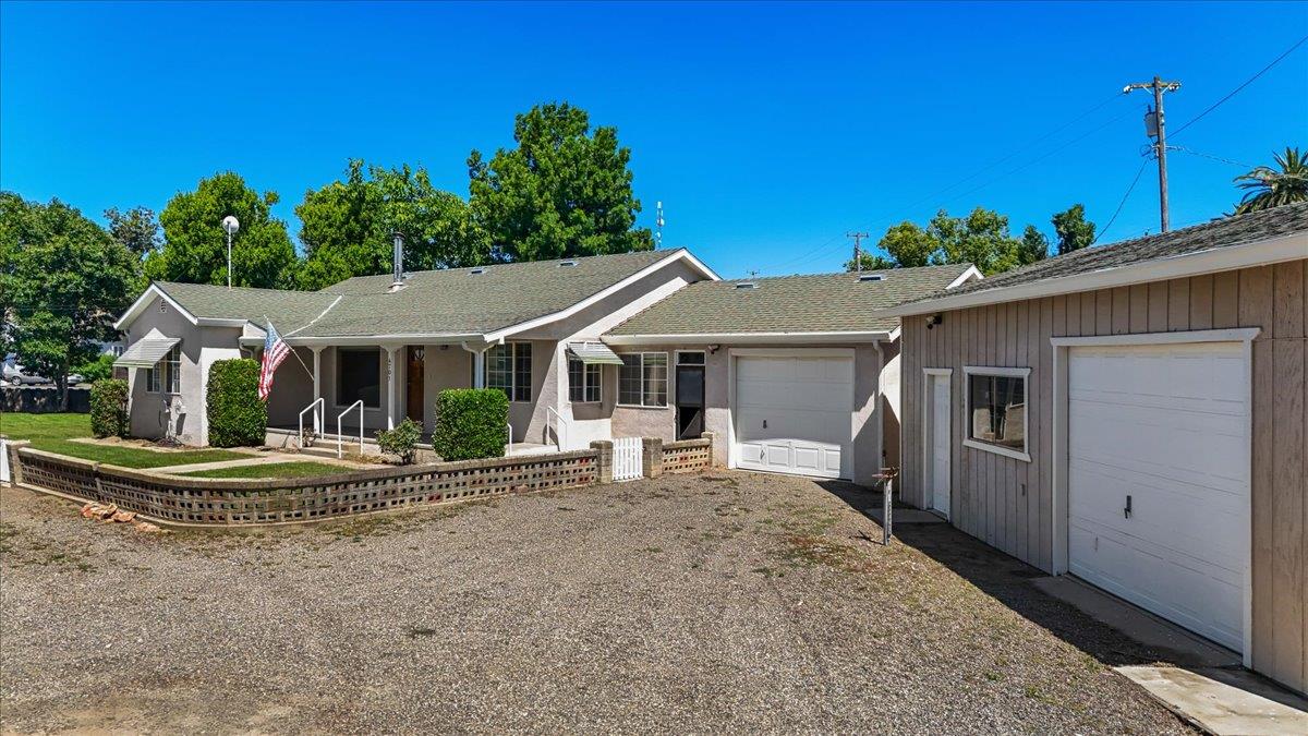 4701 Lone Tree Road Valley Home, CA 95361 - Photo 2 of 59 a front view of a house with a yard