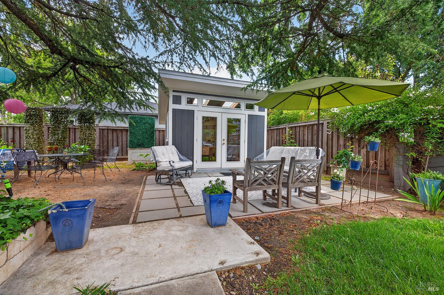 1832 Wright Street Santa Rosa, CA 95404 - Photo 20 of 25 a patio with a table and chairs under an umbrella