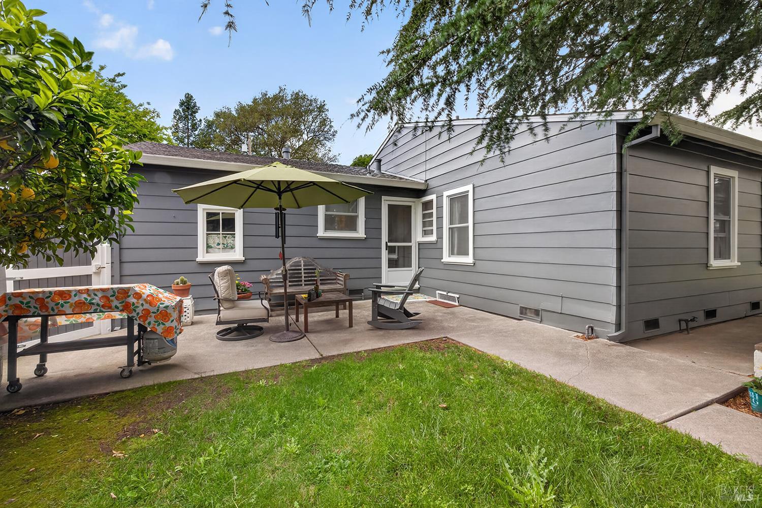 1832 Wright Street Santa Rosa, CA 95404 - Photo 24 of 25 a view of a backyard with table and chairs under an umbrella