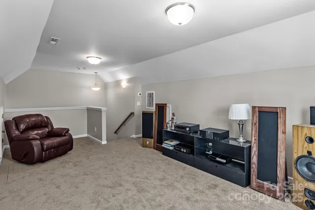 a living room with furniture gym equipment and a flat screen tv