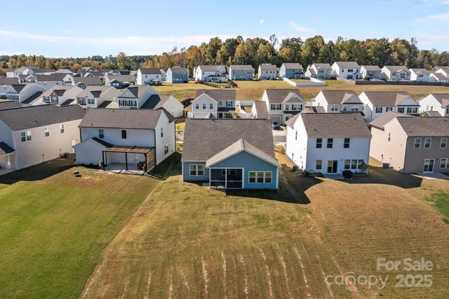 an aerial view of a house with a lake view