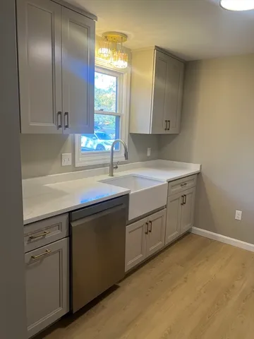 a kitchen with a sink cabinets and window