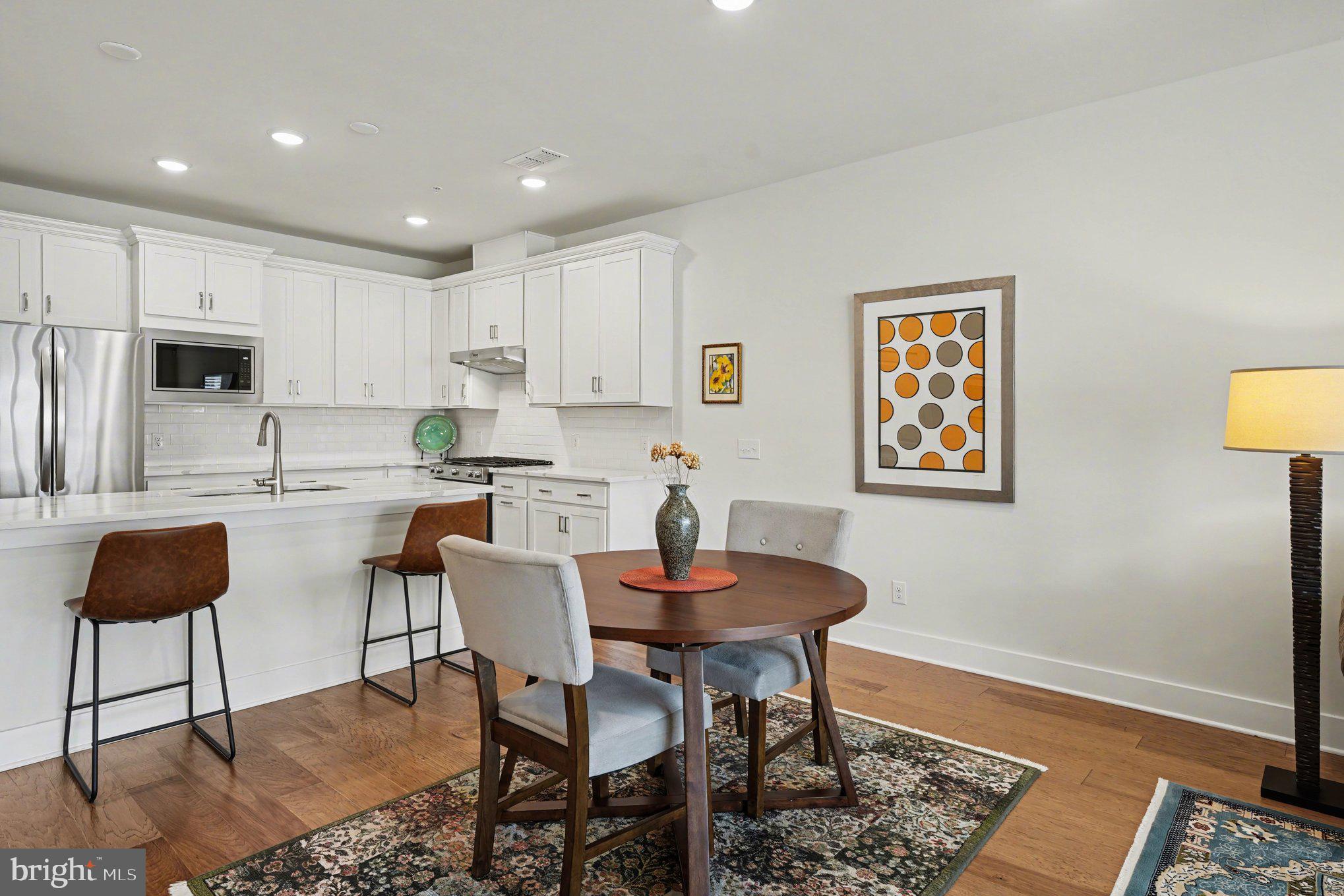 1212 Wright Street Hatfield, PA 19440 - Photo 11 of 39 a kitchen with stainless steel appliances kitchen island dining table and chairs
