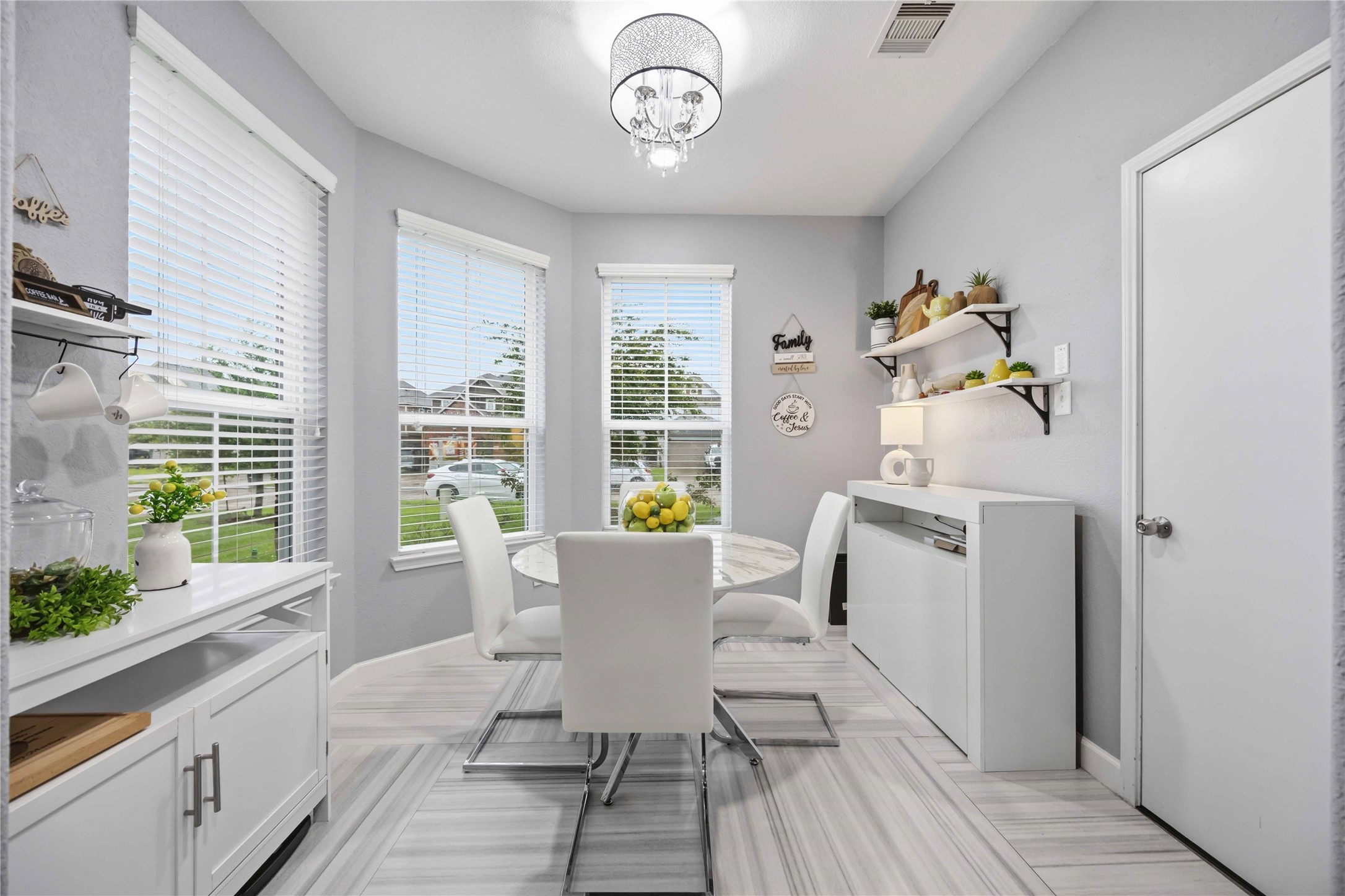 2139 Pacific Loon Lane Conroe, TX 77385 - Photo 10 of 21 Stylish breakfast nook featuring large windows, modern lighting, and sleek designer finishes with plenty of natural light throughout.