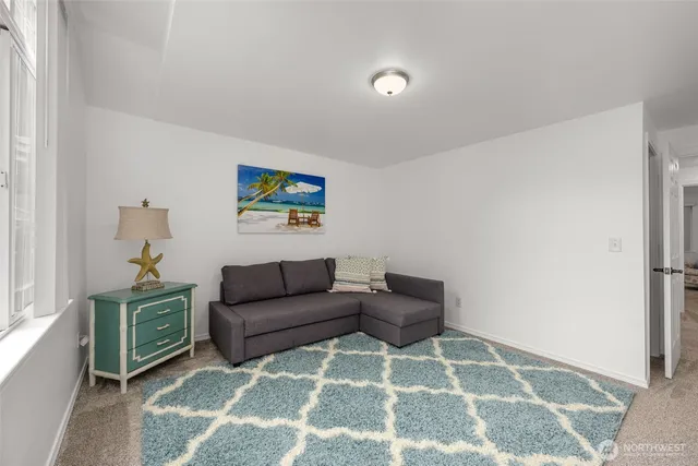 a living room with furniture and a rug