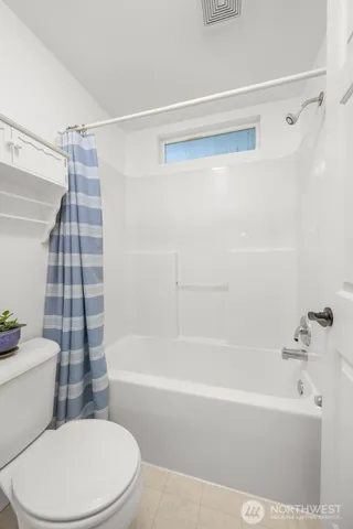 a bathroom with a bathtub and a toilet