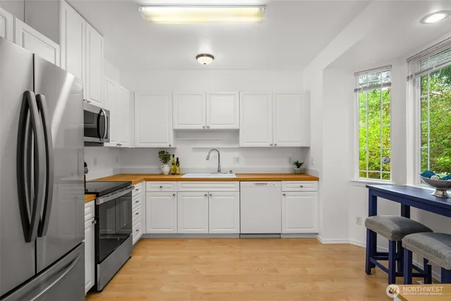 a kitchen with stainless steel appliances granite countertop a refrigerator sink and cabinets