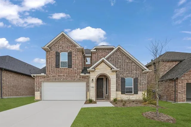 a front view of a house with a garden and plants
