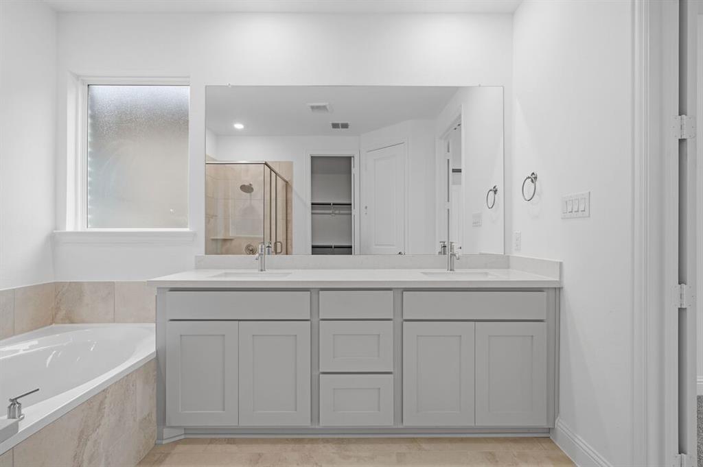 1604 Victory Circle Justin, TX 76247 - Photo 14 of 40 a bathroom with a sink and a bathtub