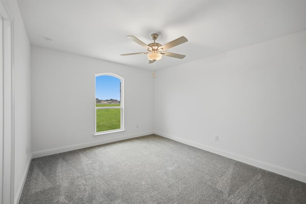 1604 Victory Circle Justin, TX 76247 - Photo 18 of 40 an empty room with windows and fan