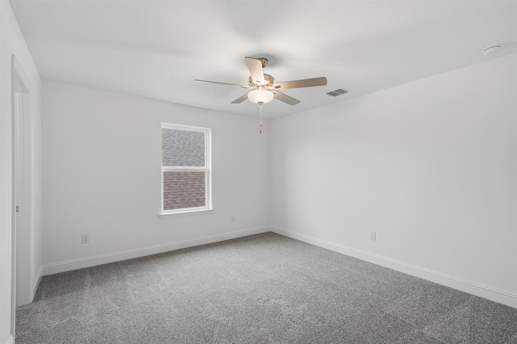 1604 Victory Circle Justin, TX 76247 - Photo 19 of 40 an empty room with a window and a fan