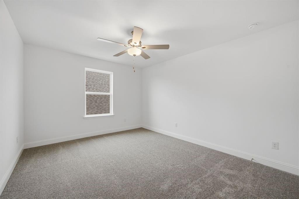 1604 Victory Circle Justin, TX 76247 - Photo 20 of 40 an empty room with a window and a fan