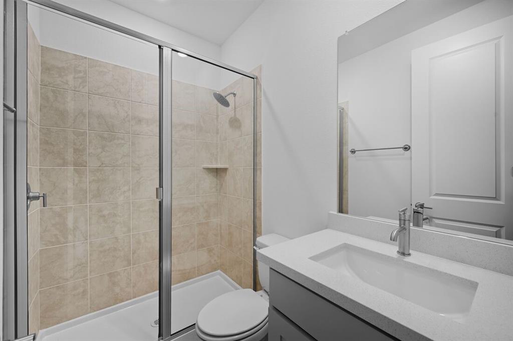 1604 Victory Circle Justin, TX 76247 - Photo 23 of 40 a bathroom with a sink toilet and shower