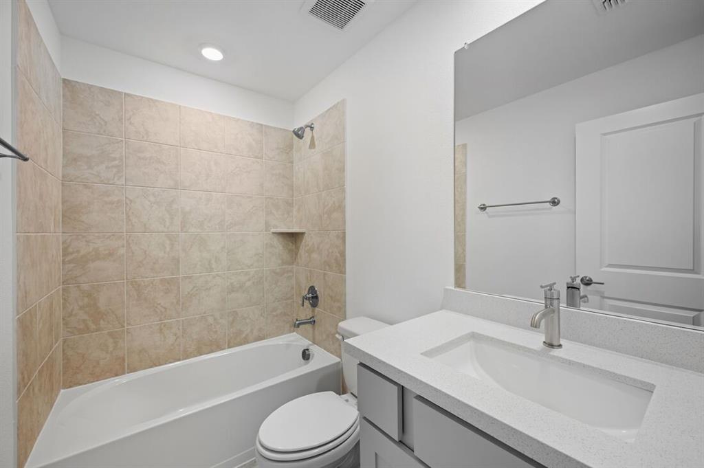 1604 Victory Circle Justin, TX 76247 - Photo 24 of 40 a bathroom with a sink a toilet and bathtub