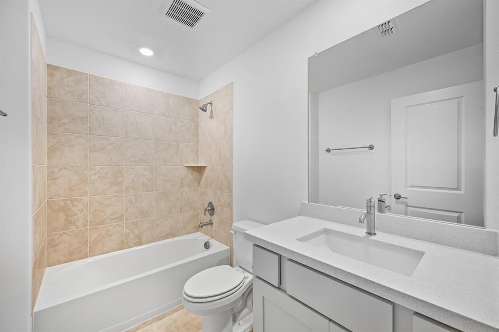 1604 Victory Circle Justin, TX 76247 - Photo 25 of 40 a bathroom with a sink a toilet and shower