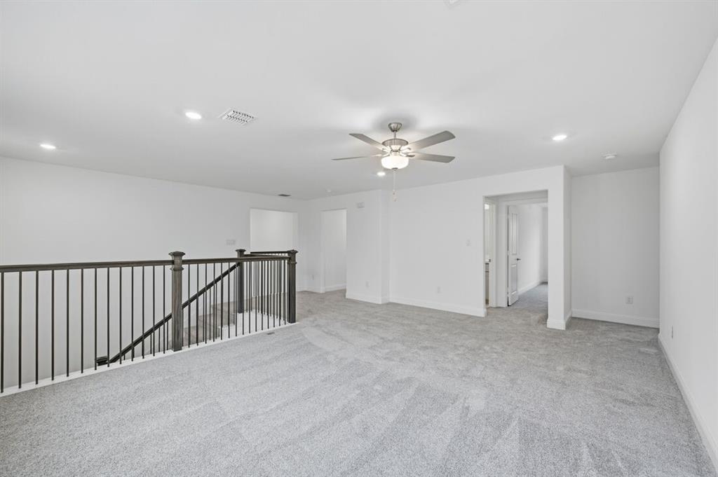 1604 Victory Circle Justin, TX 76247 - Photo 27 of 40 a view of an empty room with a chandelier fan