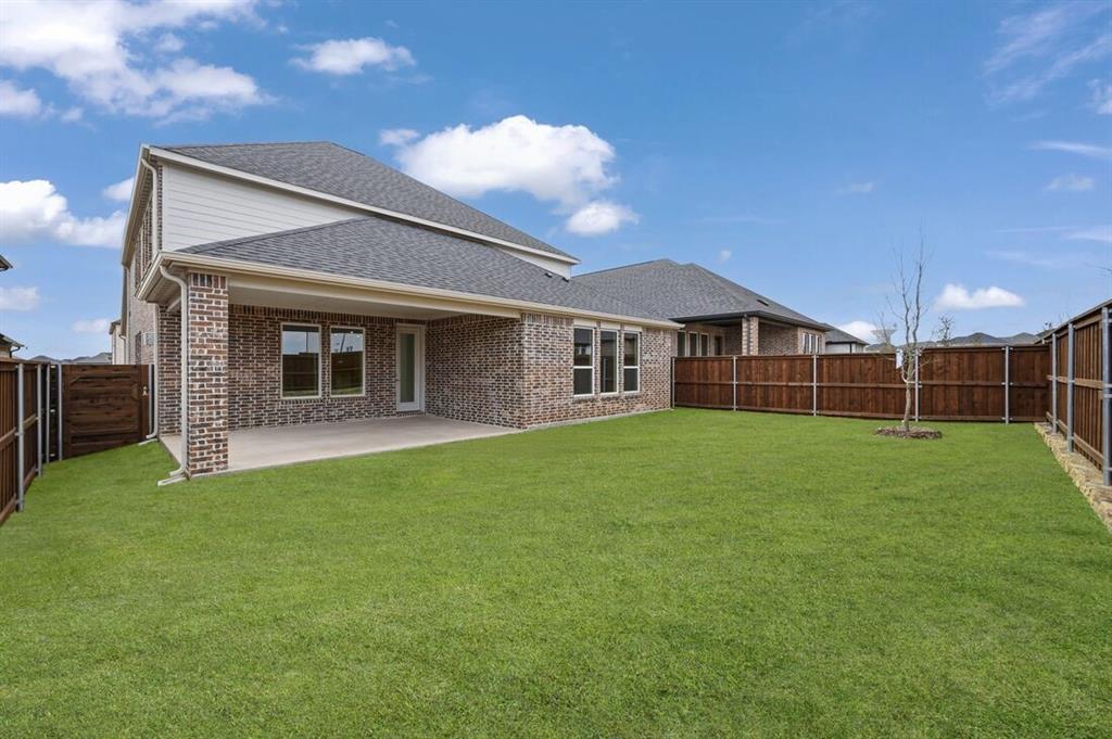 1604 Victory Circle Justin, TX 76247 - Photo 30 of 40 a view of a house with a backyard