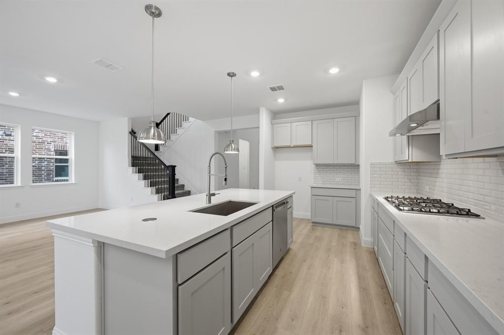 1604 Victory Circle Justin, TX 76247 - Photo 5 of 40 a kitchen with a sink stove and cabinets