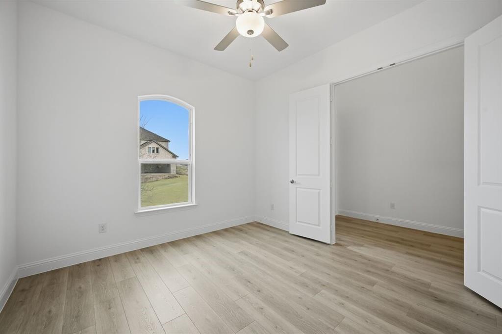 1604 Victory Circle Justin, TX 76247 - Photo 10 of 40 wooden floor in an empty room with a window