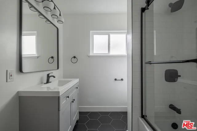 a bathroom with a sink and mirror