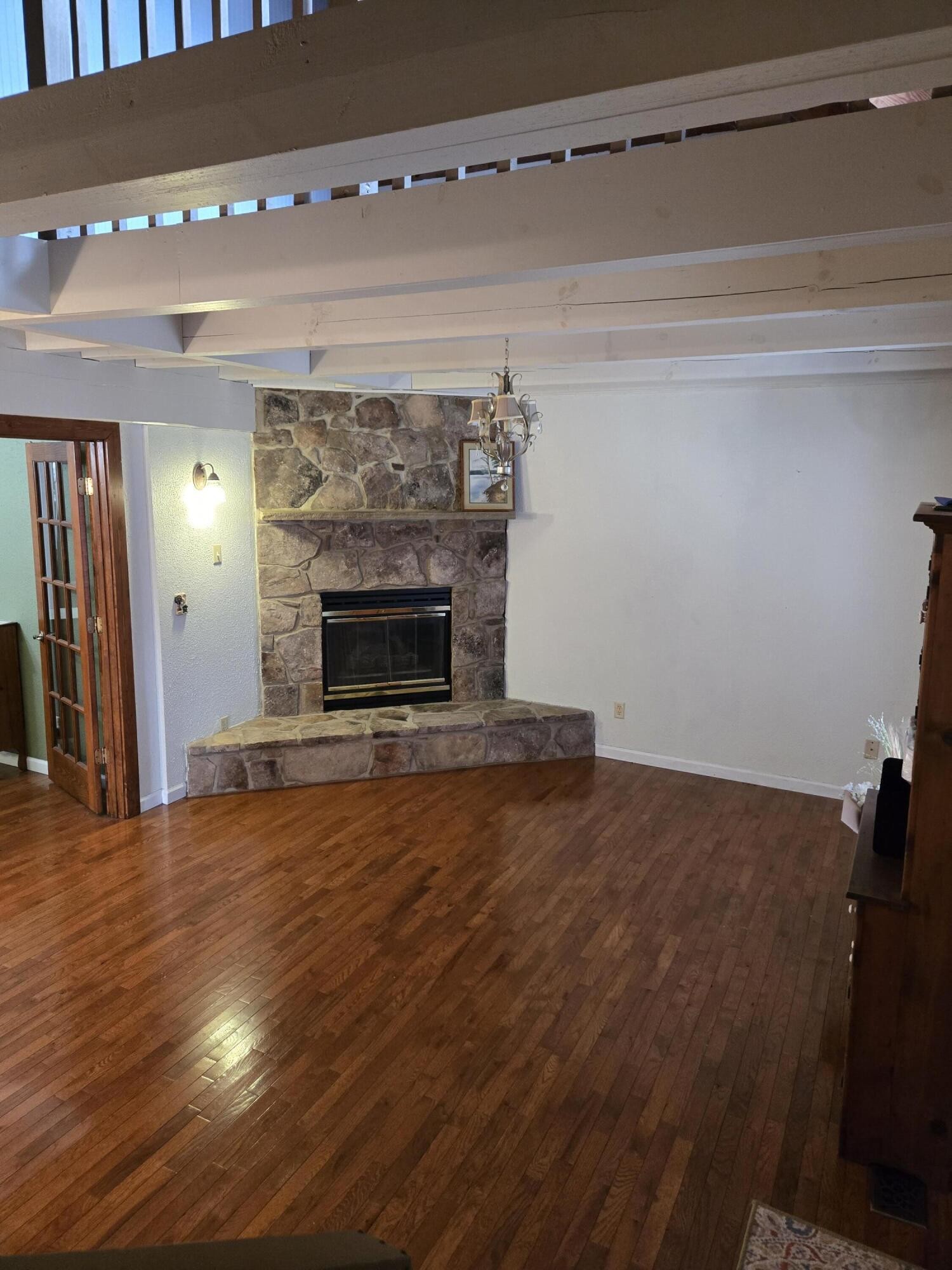 8441 Toestring Valley Road Spring City, TN 37381 - Photo 6 of 39 a view of empty room with wooden floor and fireplace
