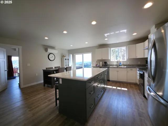 a large kitchen with a table and chairs