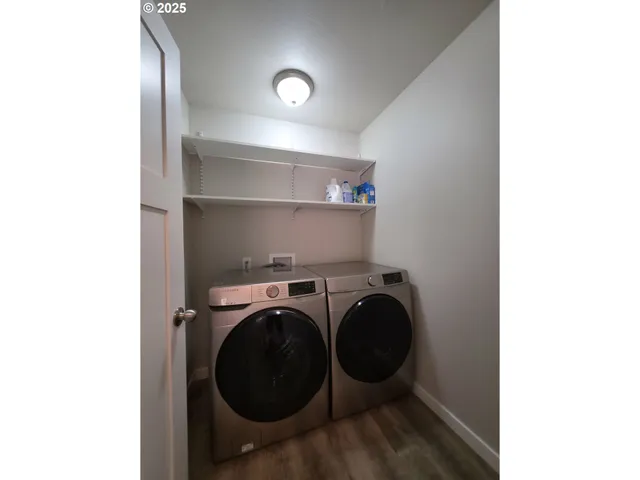 a bedroom with a bed and a flat tv screen on the dresser
